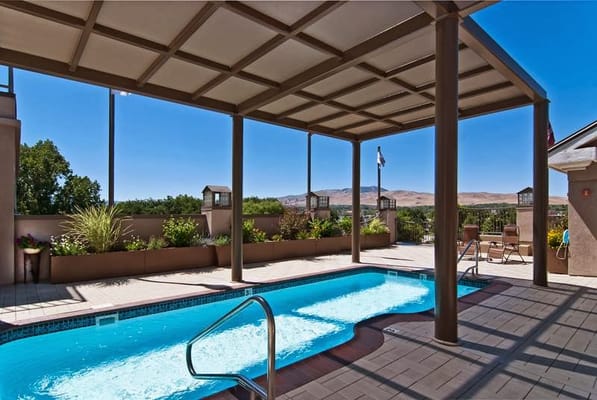 Outdoor pool area with shaded seating and views