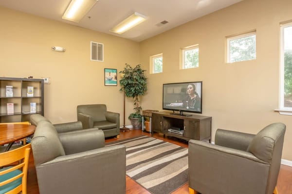 Comfortable common area with seating and a TV