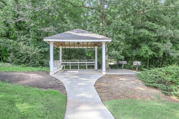 Outdoor gazebo surrounded by greenery