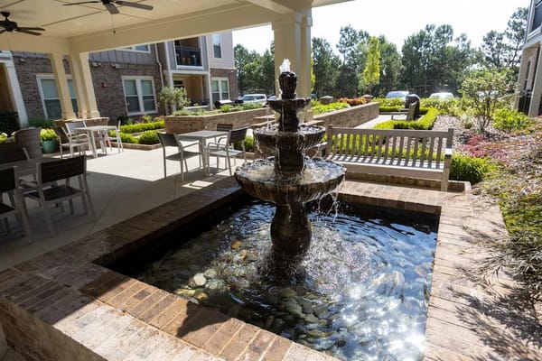 Outdoor courtyard with a fountain and seating areas