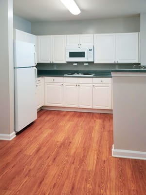 Bright interior kitchen with white cabinets and appliances