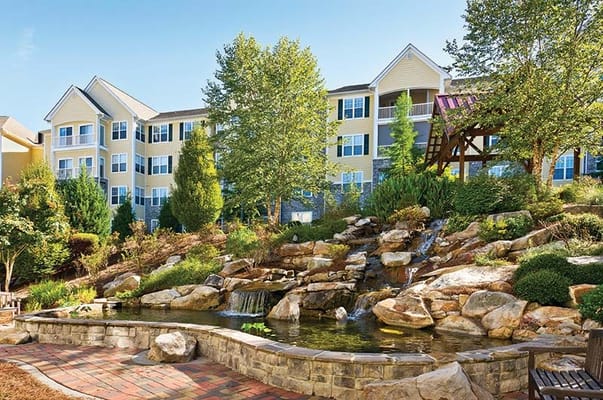 Exterior view of a senior living facility with a garden area
