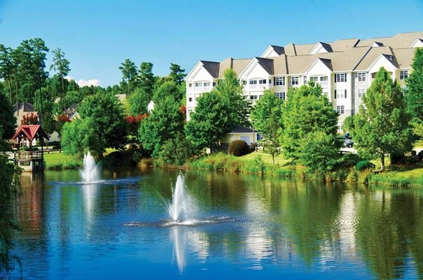 Scenic view of the facility by a pond with fountains