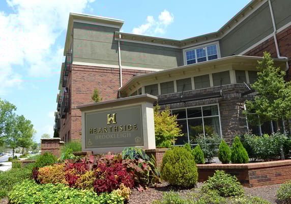 Entrance sign of Hearthside Brookleigh with landscaped flower beds