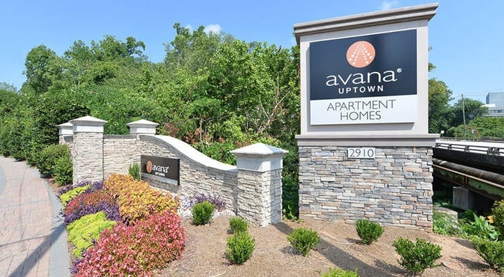 Facility entrance sign with landscaped surroundings