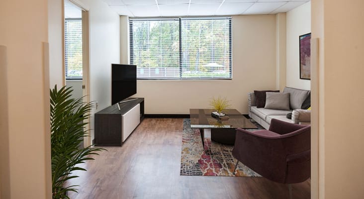 Bright living room with a television and comfortable seating