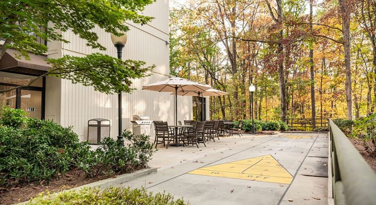 Outdoor patio with seating and umbrellas at Smyrna Towers