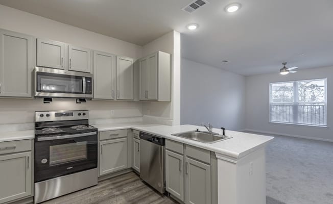 Bright kitchen with stainless steel appliances and granite countertops