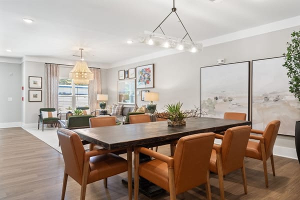 Bright, inviting common area with dining table and seating