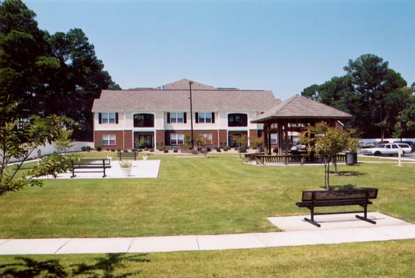 Exterior view of Ashton Meadows Apartments with gazebo and lawn