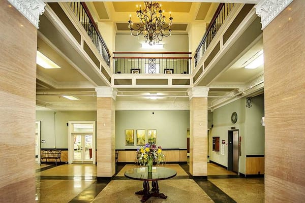 Interior view of a spacious lobby with a chandelier