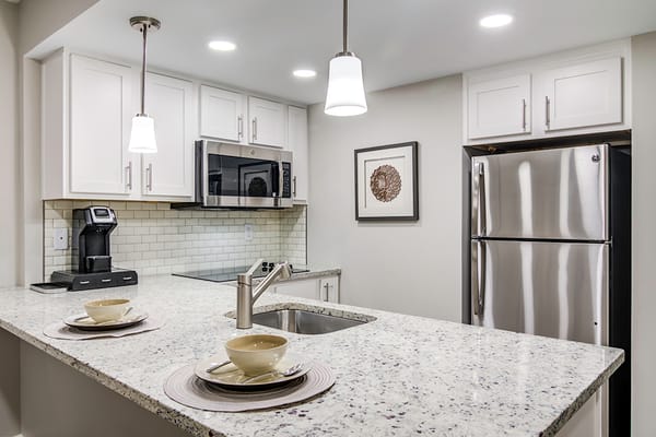 Bright kitchen with granite countertops and modern appliances