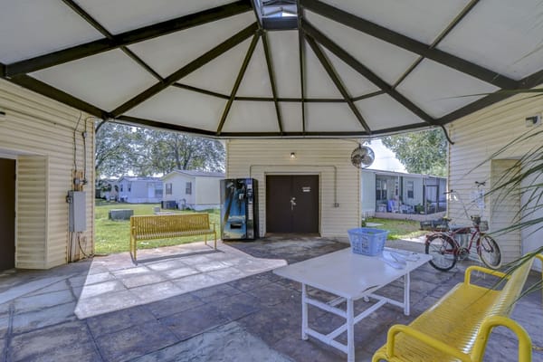 Bright common area with yellow benches and a table