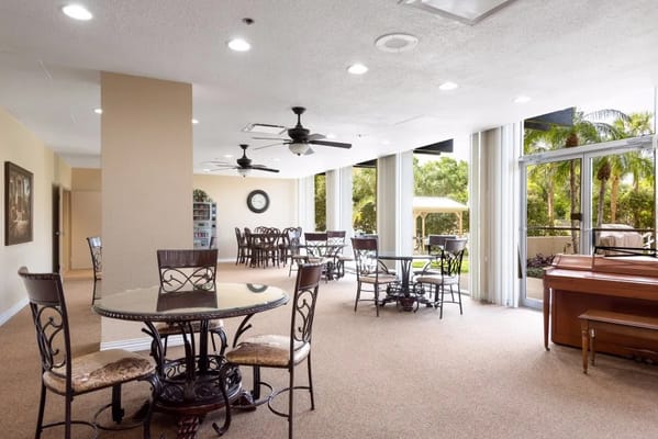 Common area with tables and seating near outdoor space