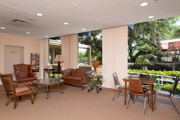 Bright common area with seating and large windows