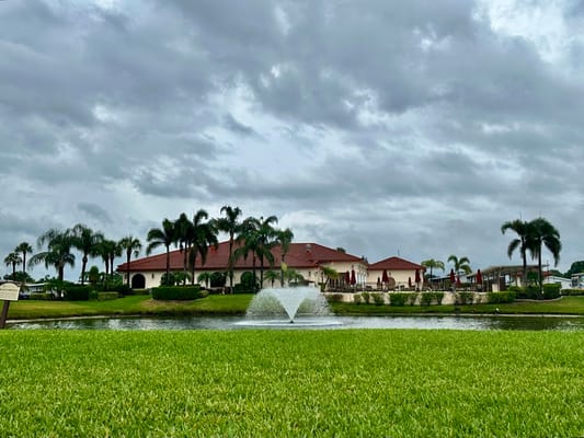 View of the lake and clubhouse at Village Green Active 55+ Community