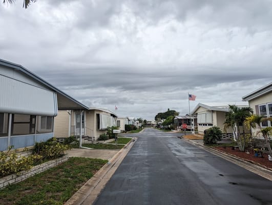 Residential street with homes and cloudy sky