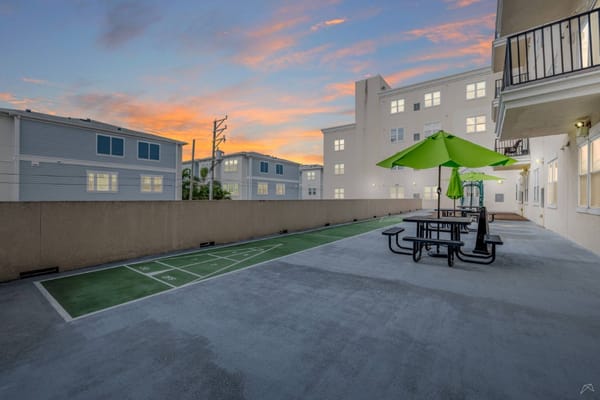 Outdoor space with a picnic area and green umbrella