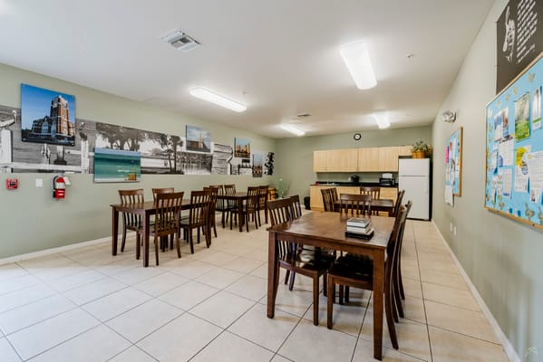 Common area with tables and kitchen access