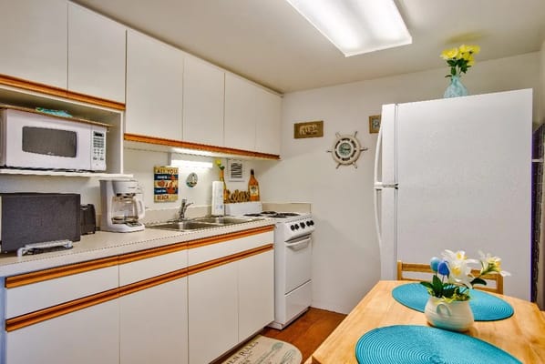 Bright kitchen area with appliances and a small table