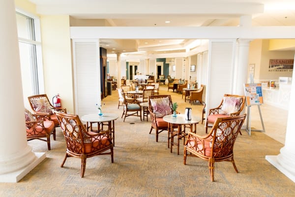 Cozy lounge area with wicker seating and tables at Sandhill Cove