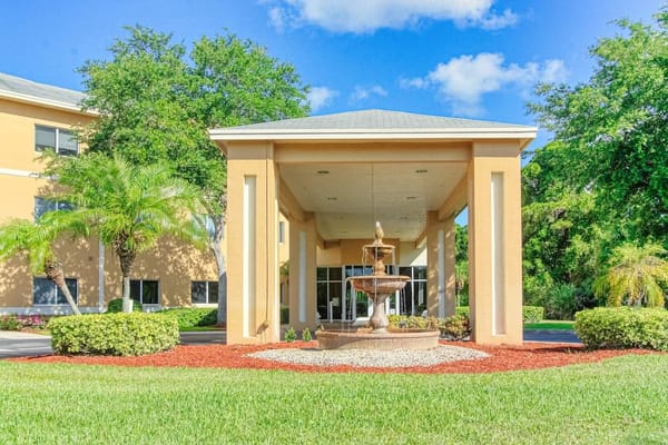 Entrance view with fountain and landscaping