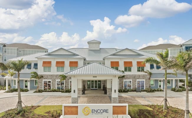 Front exterior of Encore at Tradition with logo
