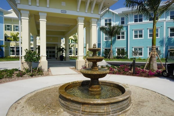 Entrance fountain of Gulf Coast Village with building in background