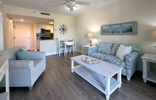 Cozy living area with furniture and kitchen visible