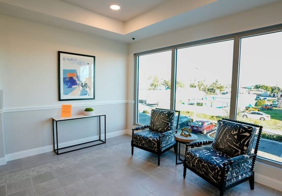 Bright interior waiting area with modern chairs and art