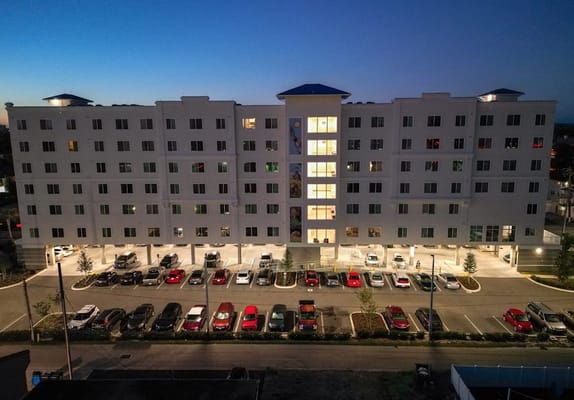 Exterior view of Madison Square Apartments at dusk