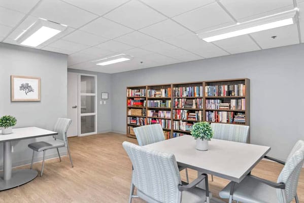 Interior of a common area with bookshelves and tables