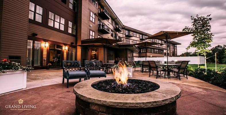 Outdoor seating area with fire pit at Grand Living