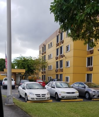 Exterior view of Vivian Villas Apartments with parked cars