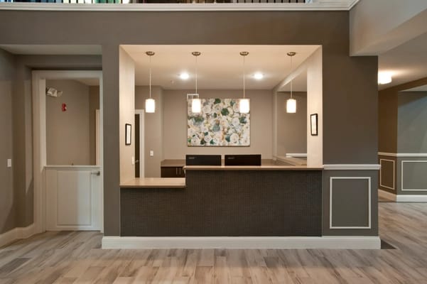 Interior view of a reception area with a floral artwork