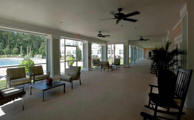 Covered outdoor seating area with a view of the pool