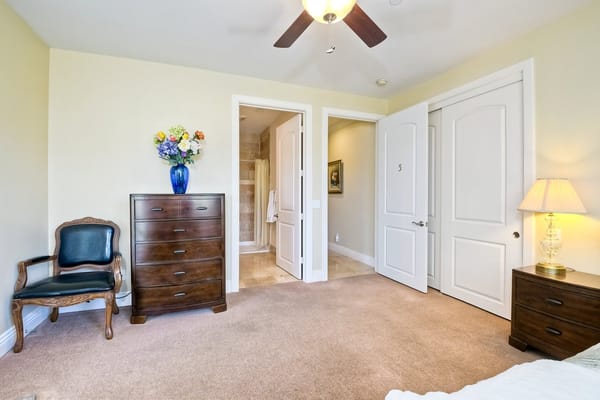 Warm and inviting bedroom with a dresser and chair.