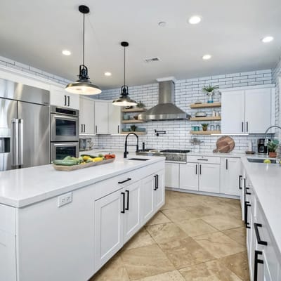 Bright and spacious kitchen with modern appliances and a fruit display.