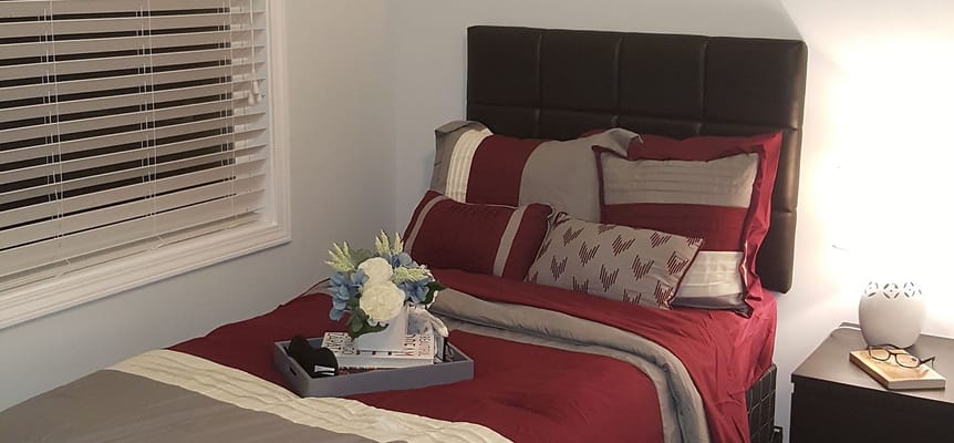 A cozy resident room with a neatly made bed