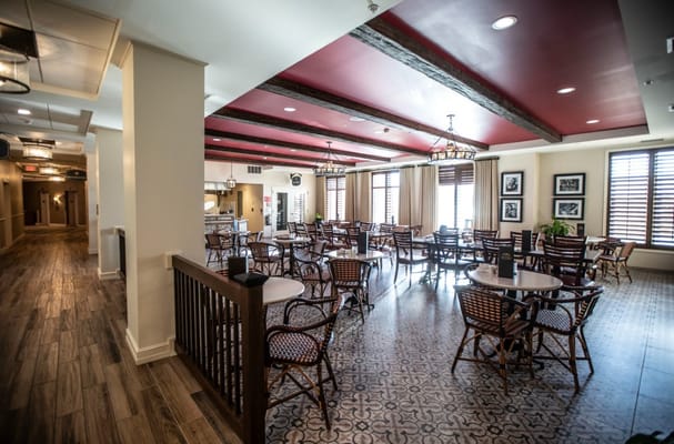 Dining area featuring tables and chairs in a senior living facility.