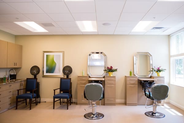 A view of the salon area with styling chairs and mirrors