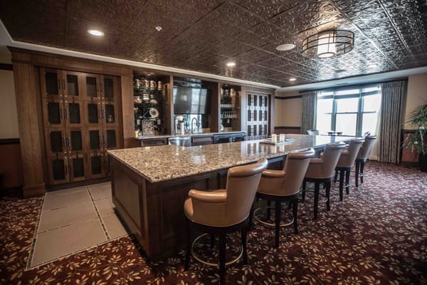 Granite countertop bar area with seating in a senior living facility