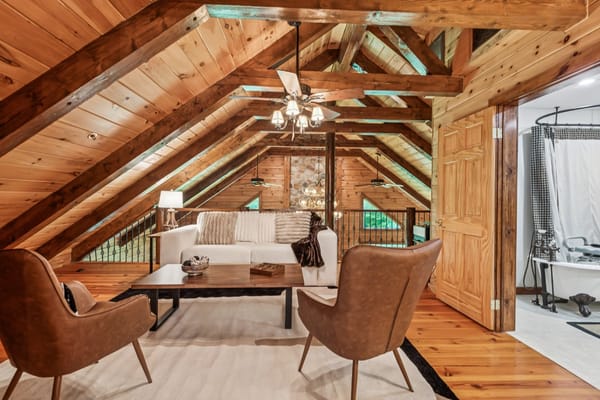 Cozy lounge area in attic with wooden beams and comfortable seating