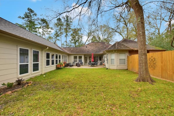Outdoor seating area with patio and lawn at Village Care Homes