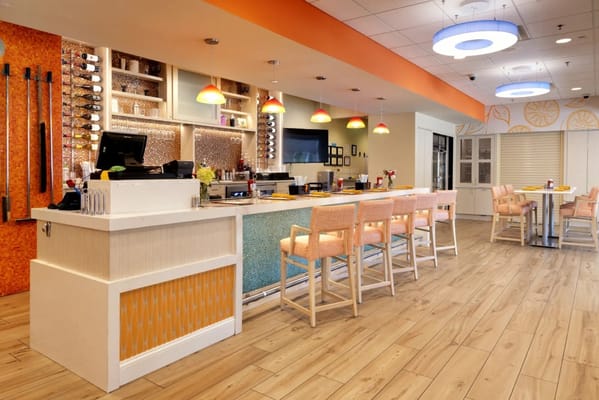 Modern dining area with bar seating and colorful decor