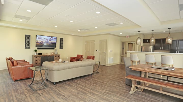 Bright common area with seating and a large TV