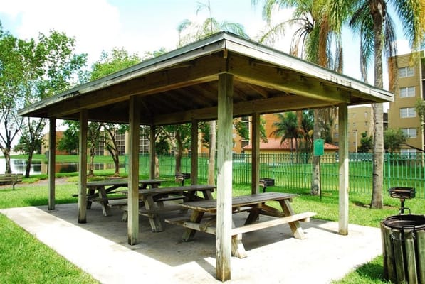Outdoor picnic area with shaded seating and tables