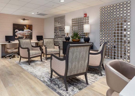 Lounge area with chairs, decorative wall, and computers in Southlake Towers.