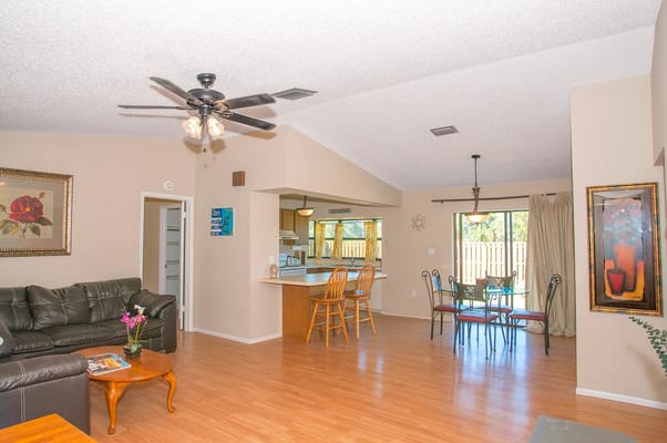 Spacious living area with a couch, dining table, and kitchen view