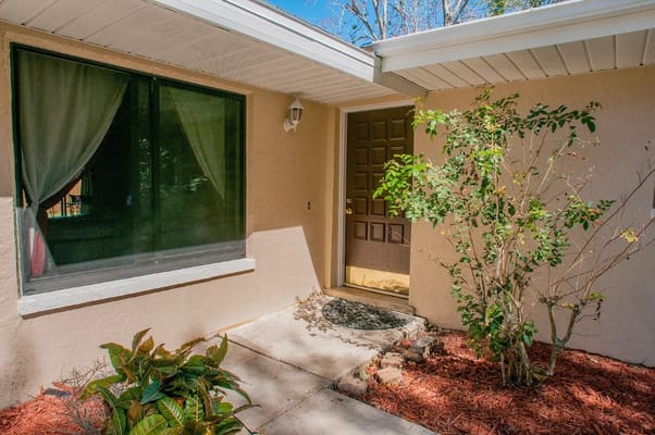 Front entrance of McKeen Towers with decorative plants